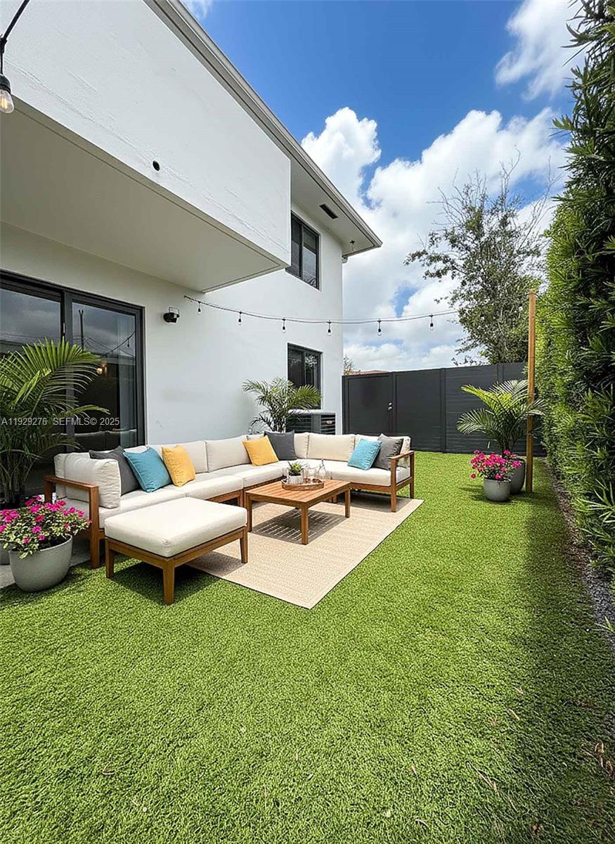 3079 Northwest 11th Street, Unit 3053 Miami, FL 33125 - Photo 9 of 11 a view of a house with backyard and sitting area