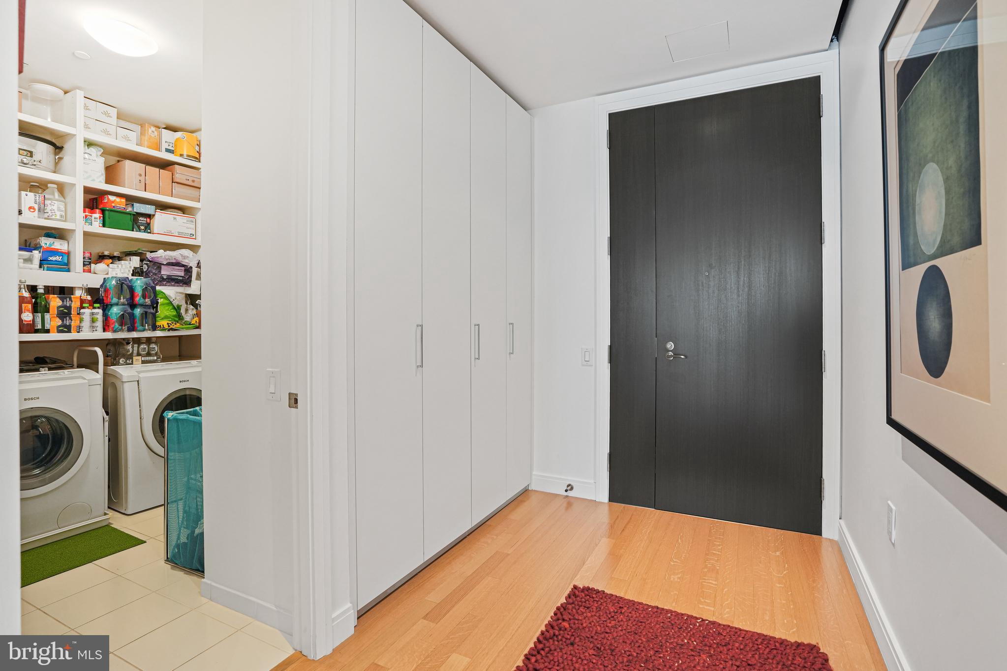 1177 22nd Street Northwest, Unit 8J Washington, DC 20037 - Photo 5 of 23 Entry Hall with view into Laundry Room