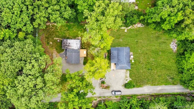 an aerial view of a house with a yard