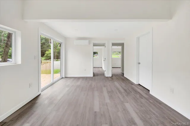 wooden floor in an empty room with a window