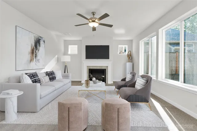 a living room with furniture a flat screen tv and a fireplace