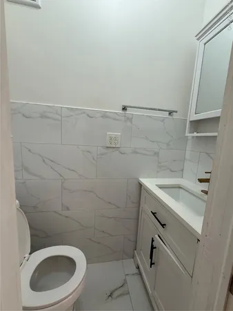 a bathroom with a sink a toilet and a shower