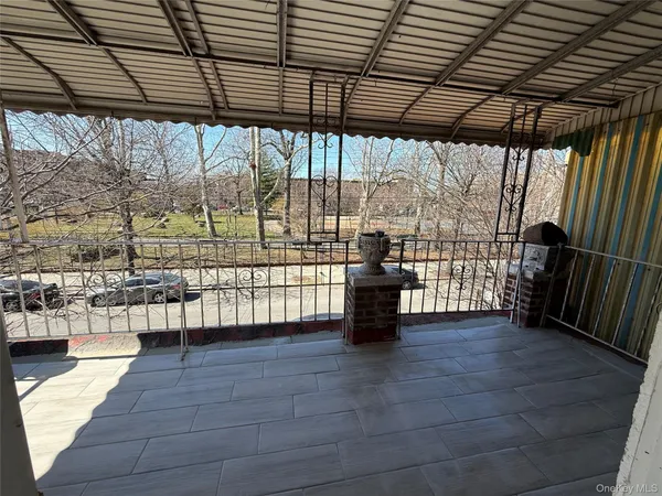 a view of a porch with wooden floor