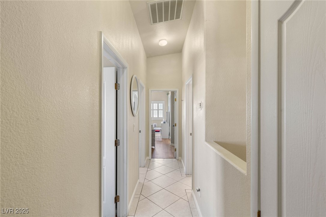 1591 Rusty Ridge Lane Henderson, NV 89002 - Photo 16 of 27 Corridor featuring a textured wall and light tile patterned floors