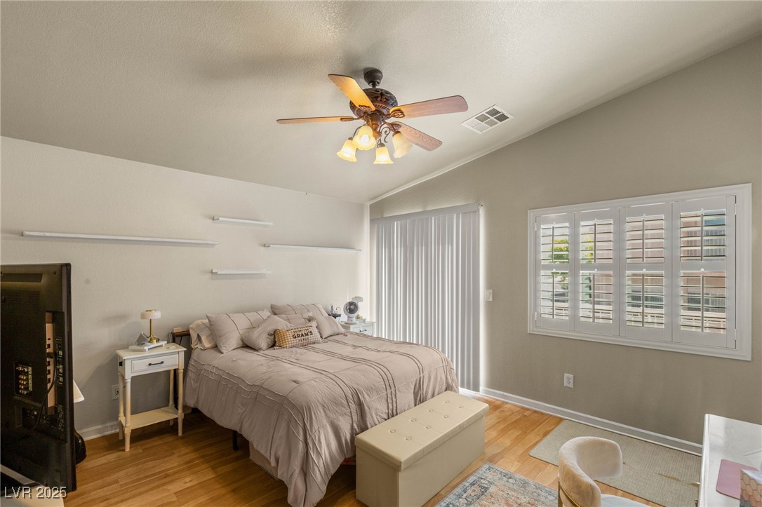 1591 Rusty Ridge Lane Henderson, NV 89002 - Photo 17 of 27 Bedroom featuring light wood-style flooring, lofted ceiling, and a ceiling fan