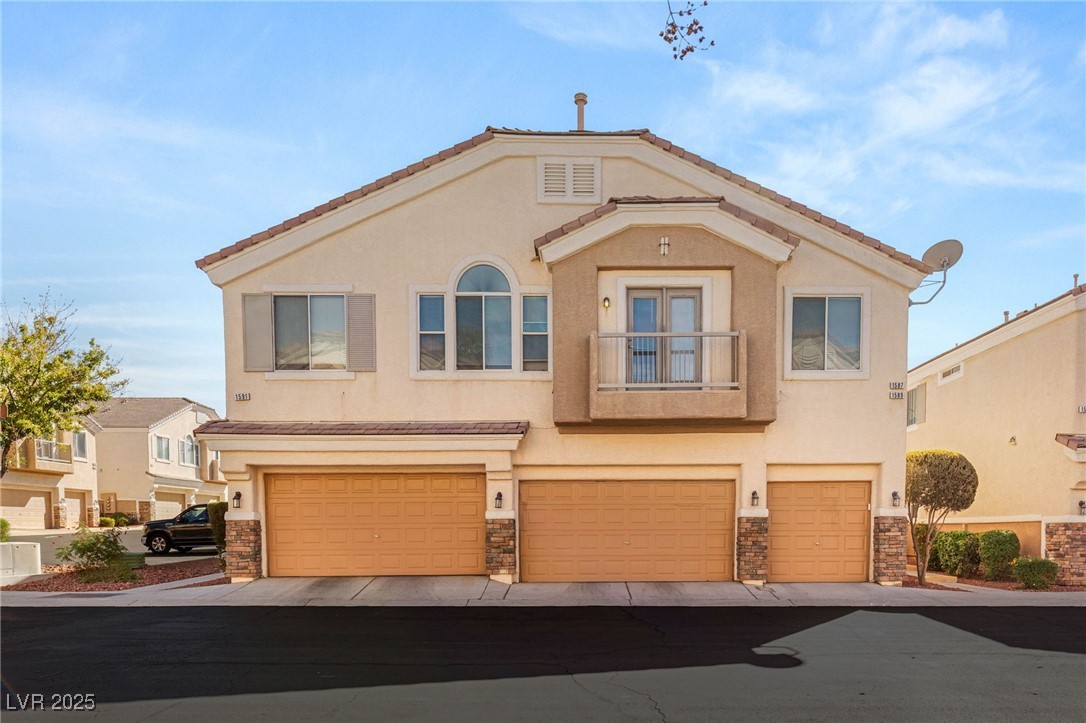1591 Rusty Ridge Lane Henderson, NV 89002 - Photo 2 of 27 Mediterranean / spanish house featuring a balcony, stucco siding, and stone siding