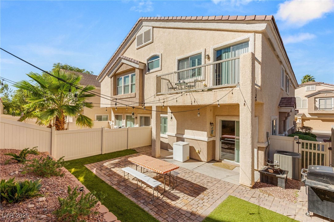 1591 Rusty Ridge Lane Henderson, NV 89002 - Photo 25 of 27 Back of house featuring a fenced backyard, a balcony, a patio area, and stucco siding
