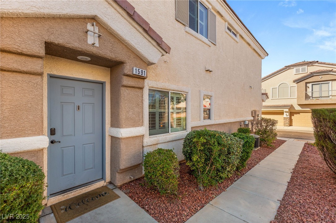1591 Rusty Ridge Lane Henderson, NV 89002 - Photo 4 of 27 Doorway to property featuring stucco siding