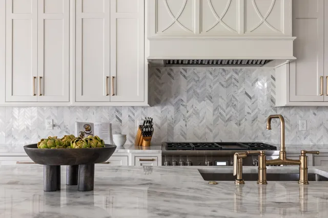 a kitchen with a counter space a sink appliances and living room view