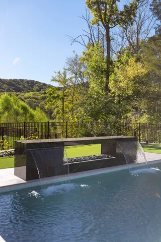 swimming pool view with a seating space