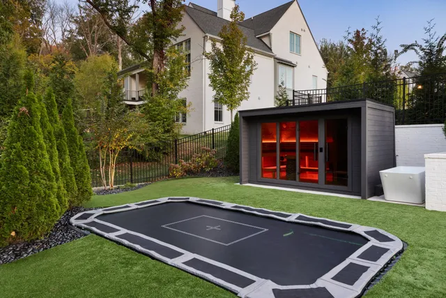 a swimming pool with outdoor seating and yard