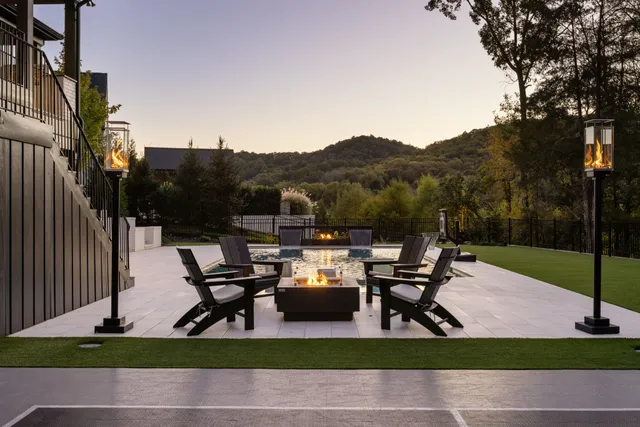 a view of a patio with table and chairs with wooden floor and fence