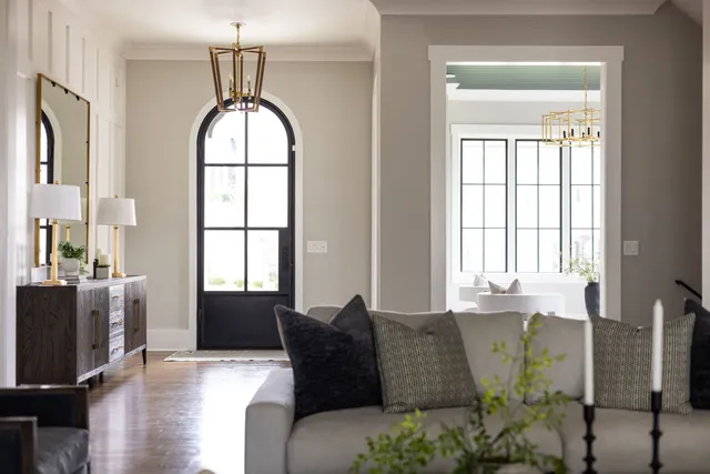 a living room with furniture and large windows