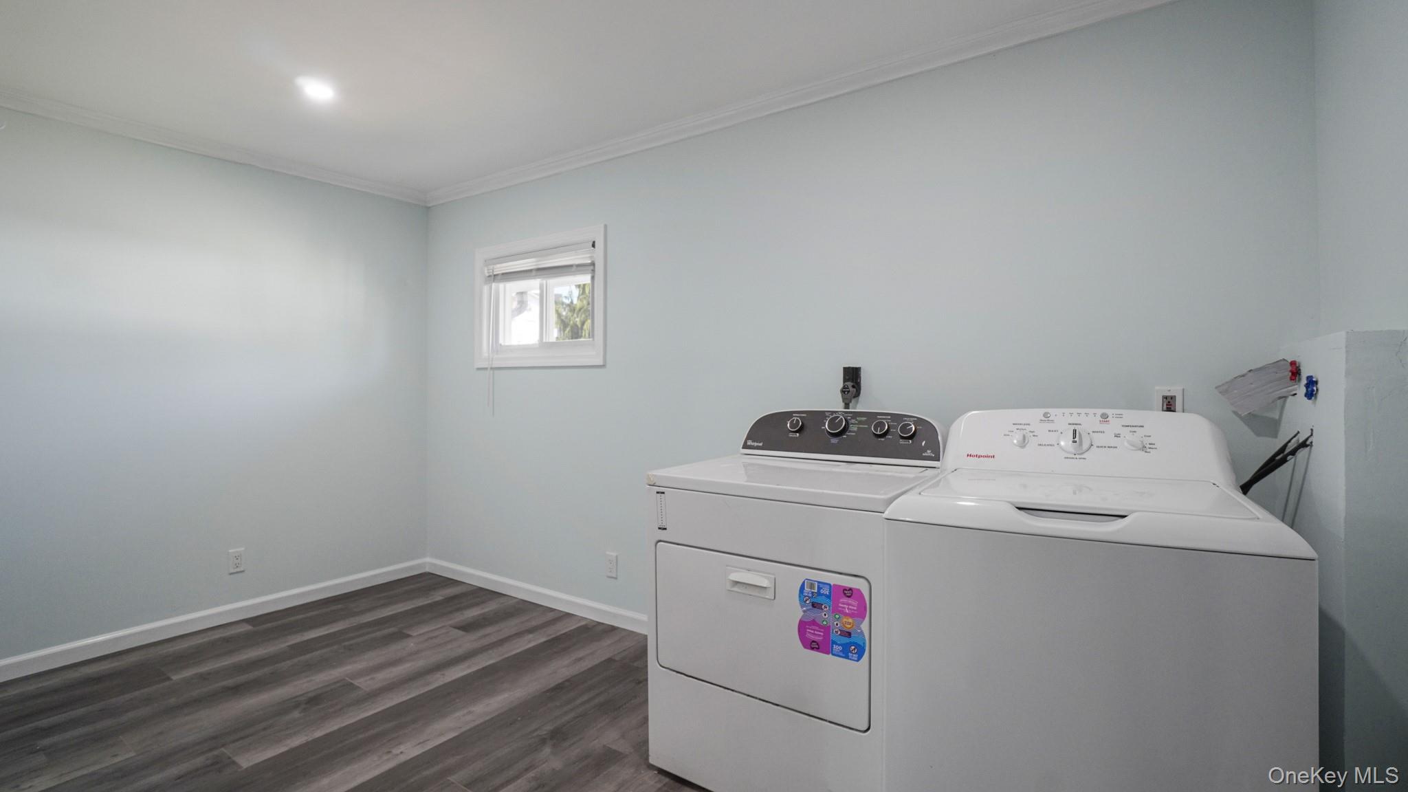 63 Blacksmith Road Levittown, NY 11756 - Photo 7 of 25 Dedicated laundry area featuring a light blue wall finish, wood-finish flooring, recessed lighting, white baseboards, and a window with blinds