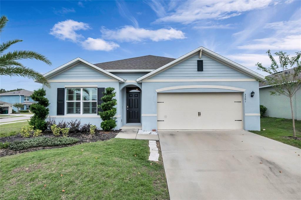 a front view of a house with a yard and garage