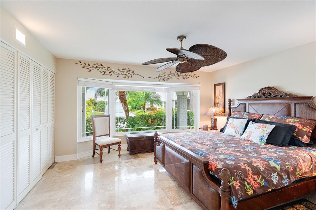 402 Devonshire Lane Venice, FL 34293 - Photo 11 of 52 a bed room with a bed and a chair