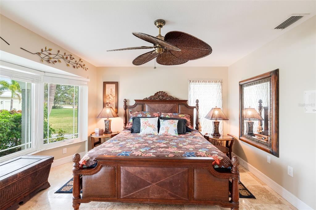 402 Devonshire Lane Venice, FL 34293 - Photo 12 of 52 a bed sitting in a bedroom next to a window