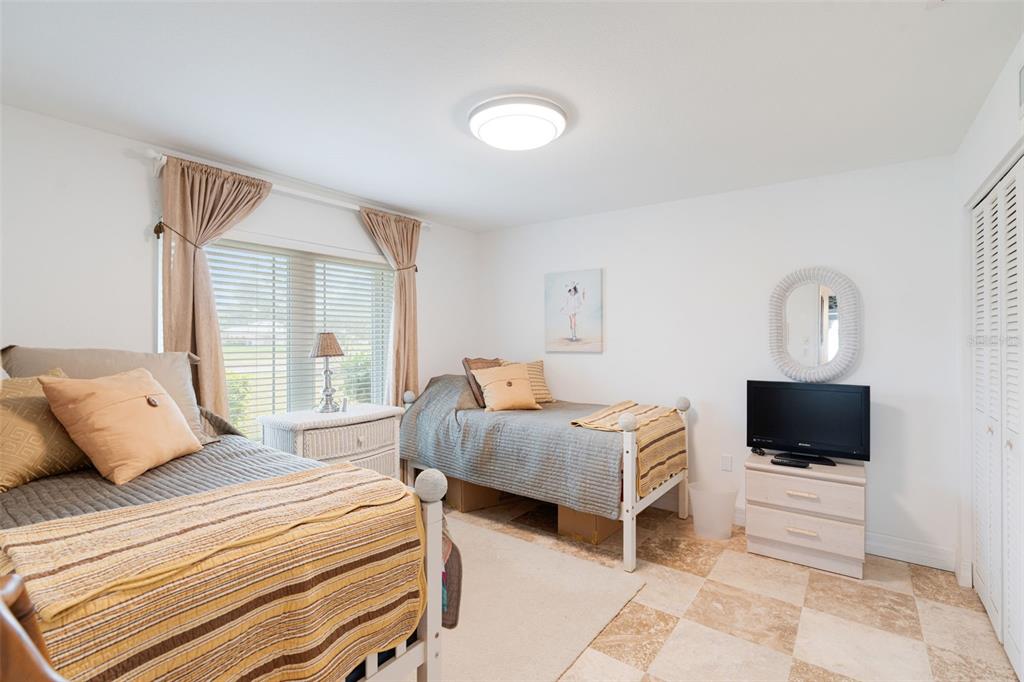 402 Devonshire Lane Venice, FL 34293 - Photo 13 of 52 a bedroom with a bed and a television