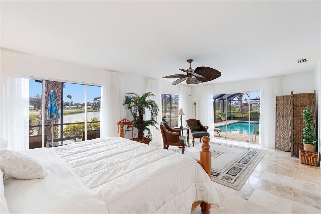402 Devonshire Lane Venice, FL 34293 - Photo 18 of 52 a bedroom with a bed and large windows