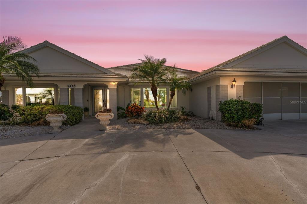 402 Devonshire Lane Venice, FL 34293 - Photo 2 of 52 a front view of a house with garden