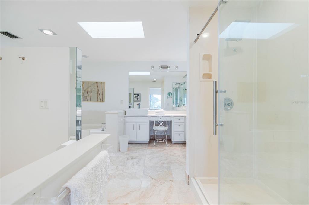 402 Devonshire Lane Venice, FL 34293 - Photo 21 of 52 a bathroom with a tub sink shower and view living room