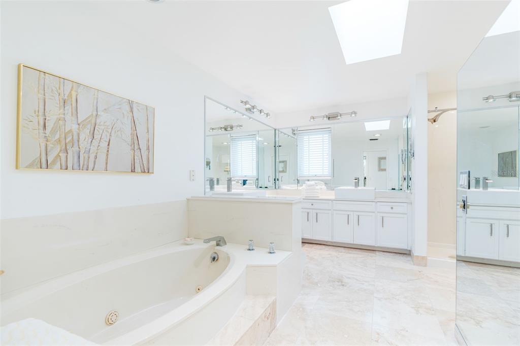 402 Devonshire Lane Venice, FL 34293 - Photo 22 of 52 a bathroom with a bathtub a double vanity sink and a bathtub