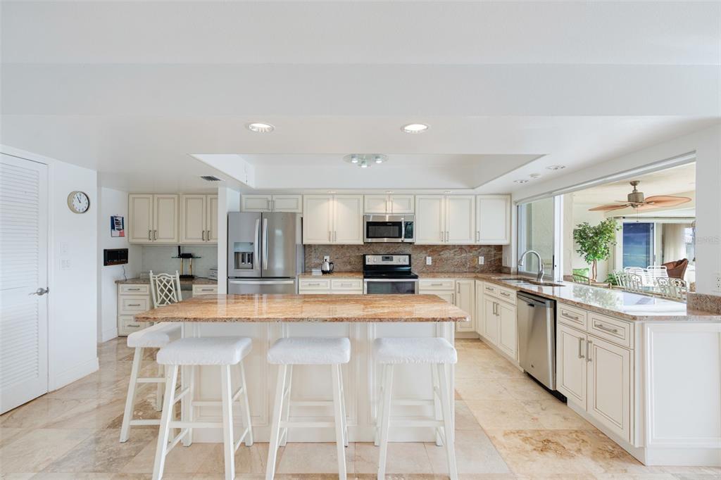 402 Devonshire Lane Venice, FL 34293 - Photo 29 of 52 a kitchen with stainless steel appliances kitchen island granite countertop a sink and cabinets