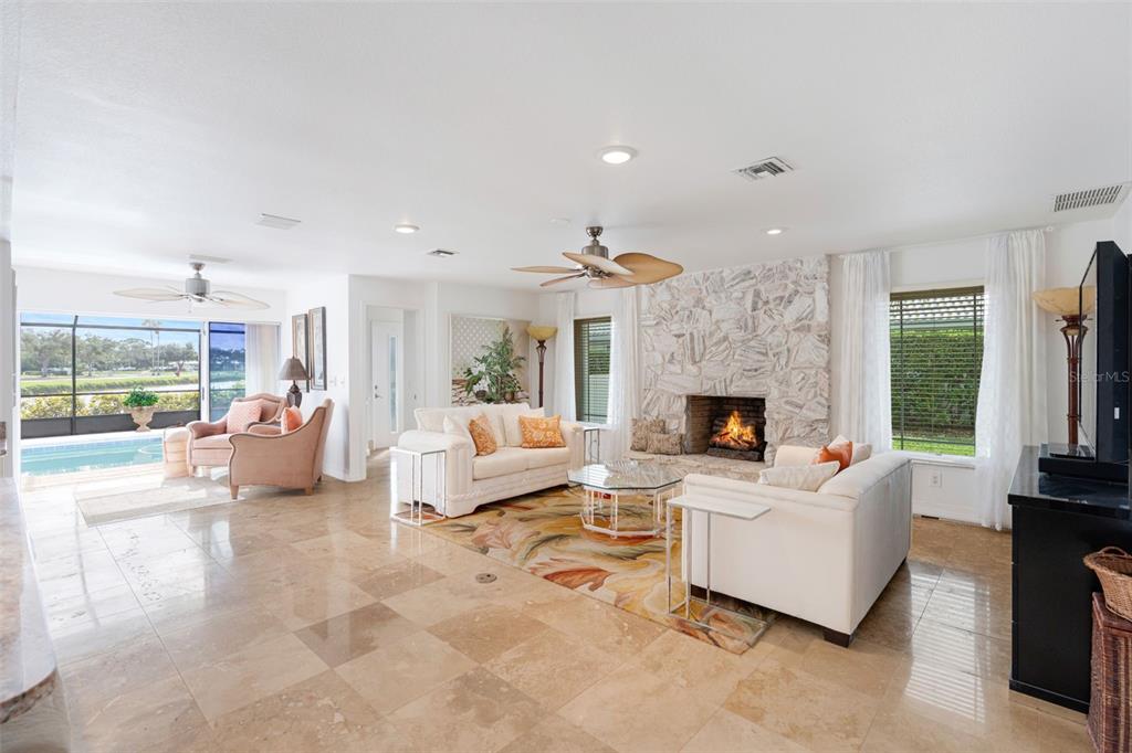 402 Devonshire Lane Venice, FL 34293 - Photo 31 of 52 a living room with furniture and a fireplace