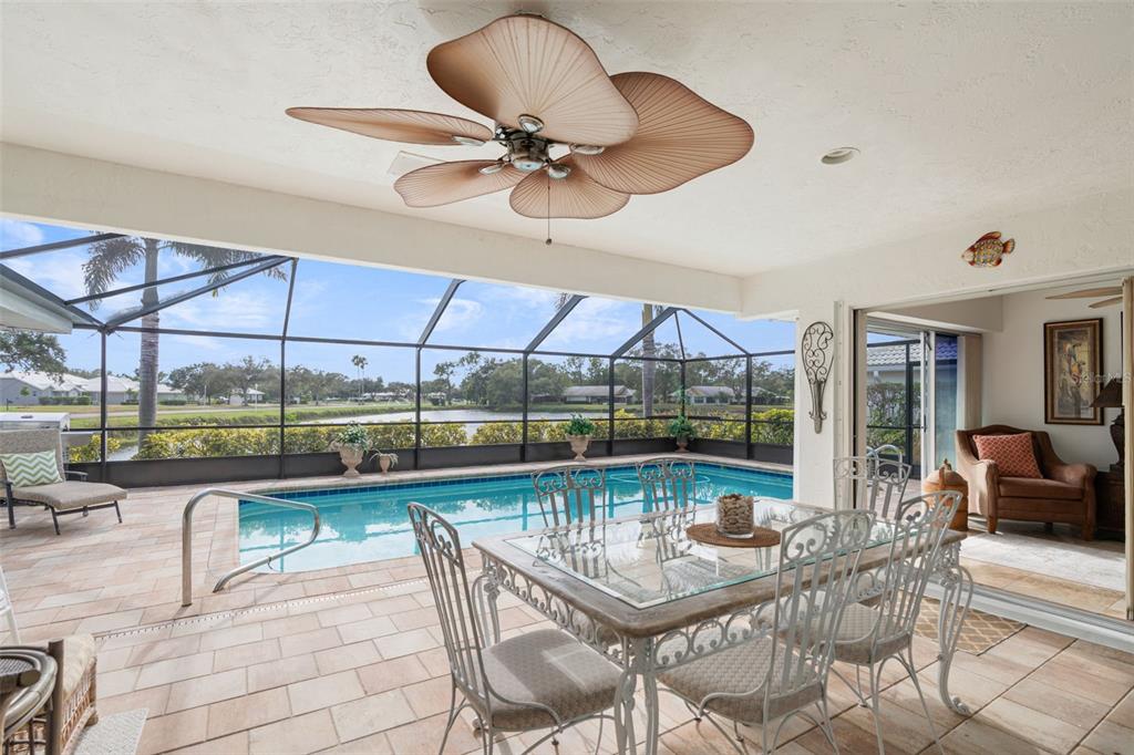 402 Devonshire Lane Venice, FL 34293 - Photo 37 of 52 a dining room with furniture and a floor to ceiling window