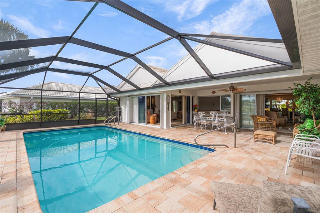 402 Devonshire Lane Venice, FL 34293 - Photo 39 of 52 a view of a patio with a table and chairs under an umbrella