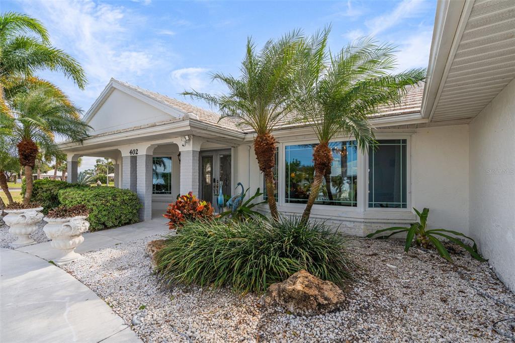 402 Devonshire Lane Venice, FL 34293 - Photo 45 of 52 a front view of a house with porch and glass windows