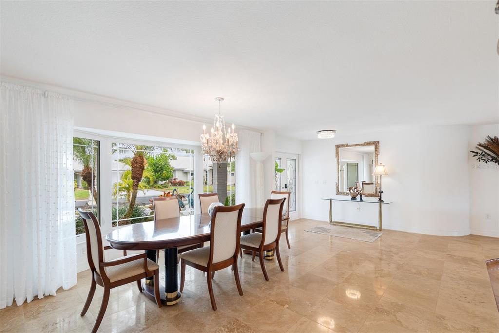 402 Devonshire Lane Venice, FL 34293 - Photo 6 of 52 a view of a dining room with furniture window and wooden floor