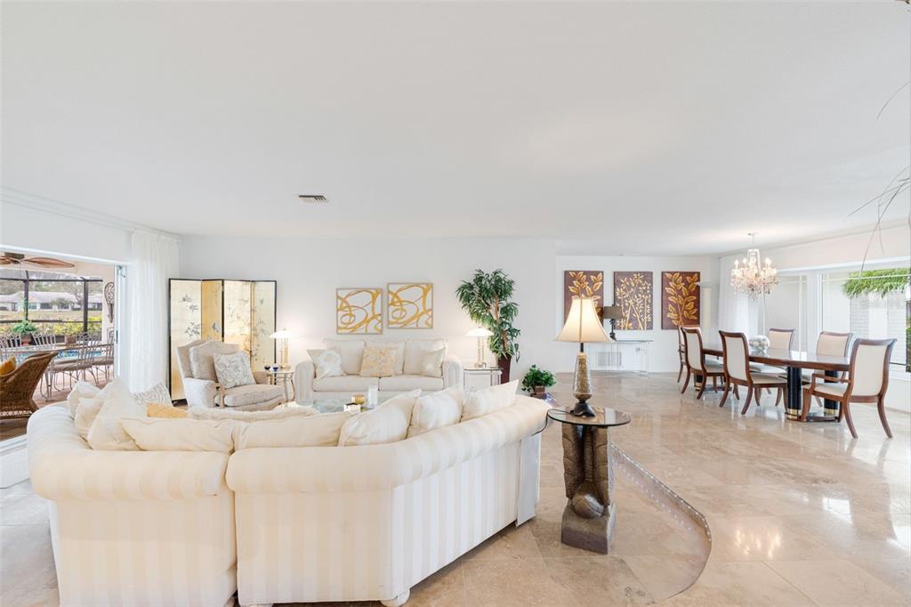 402 Devonshire Lane Venice, FL 34293 - Photo 7 of 52 a living room with furniture and a large window