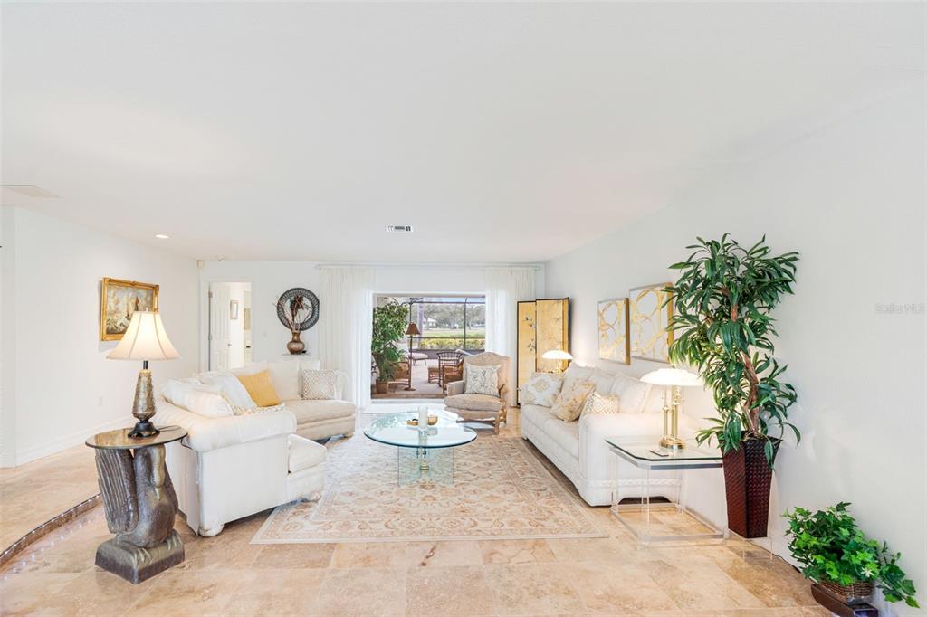 402 Devonshire Lane Venice, FL 34293 - Photo 9 of 52 a living room with furniture and a potted plant