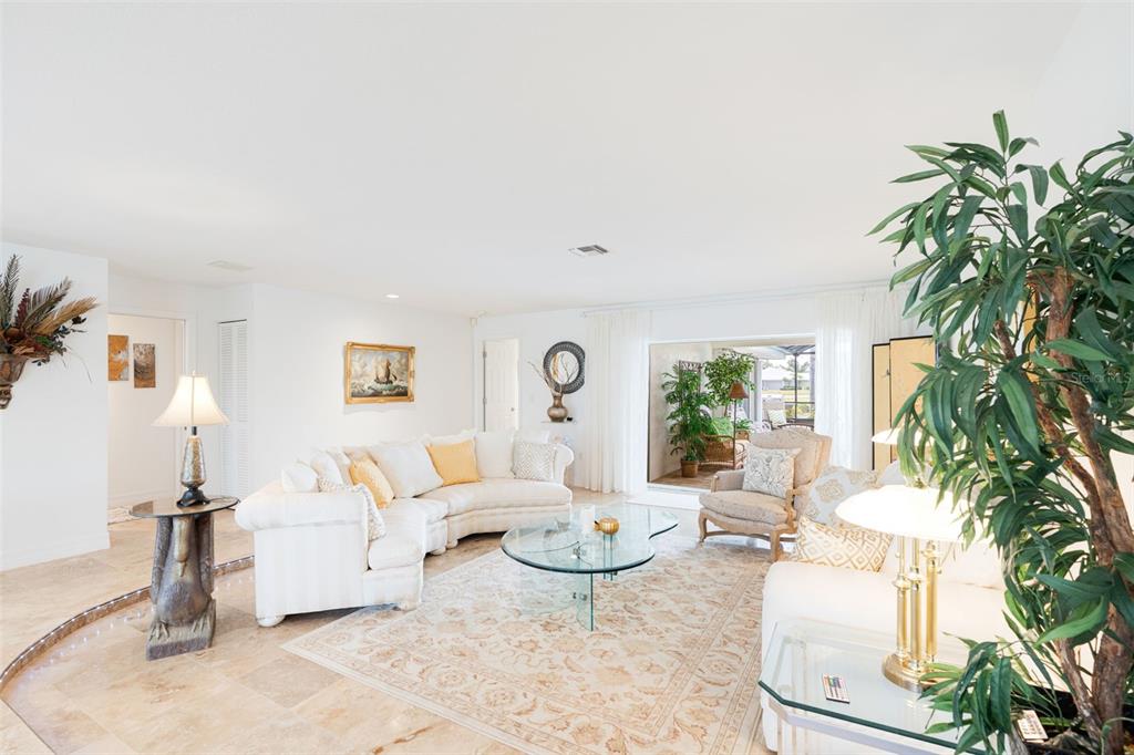 402 Devonshire Lane Venice, FL 34293 - Photo 10 of 52 a living room with furniture and a potted plant