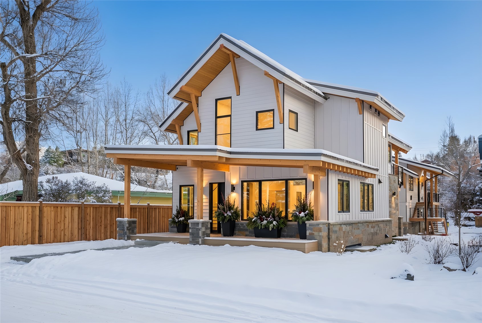 119 Spruce Street Steamboat Springs, CO 80487 - Photo 30 of 38 Snow covered back of property with board and batten siding, stone siding, and covered porch Winter View