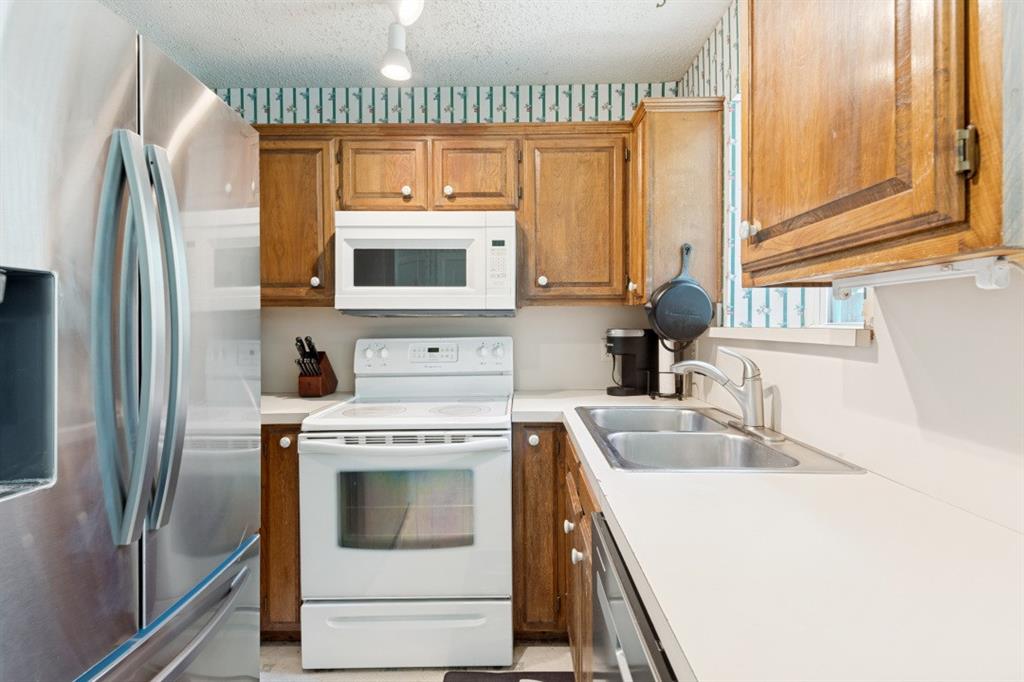 7410 Jessica Way Rowlett, TX 75088 - Photo 10 of 25 a kitchen with a sink stove and refrigerator