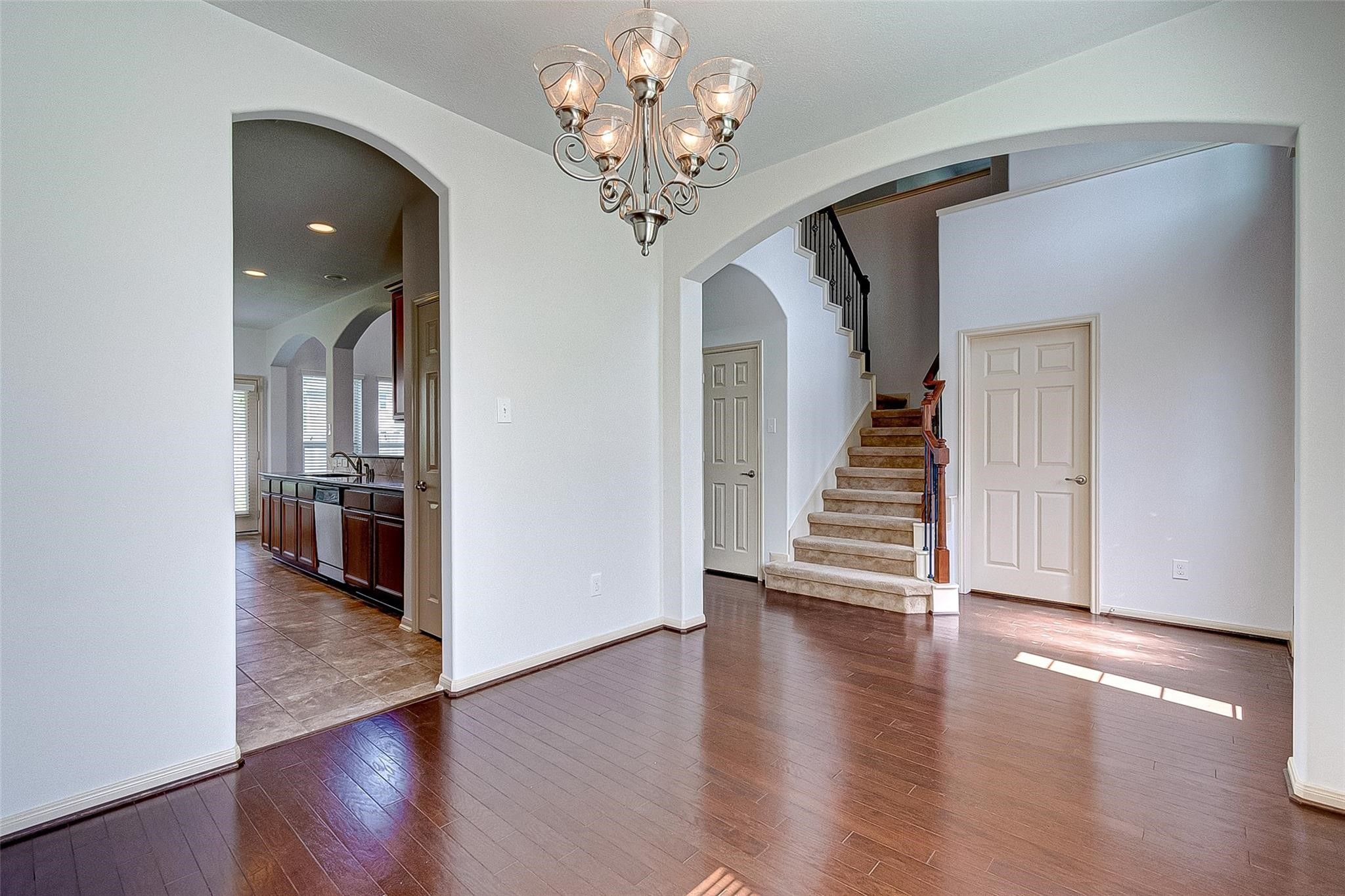 79 West Lasting Spring Circle Spring, TX 77389 - Photo 13 of 48 a view of a hallway with wooden floor and staircase