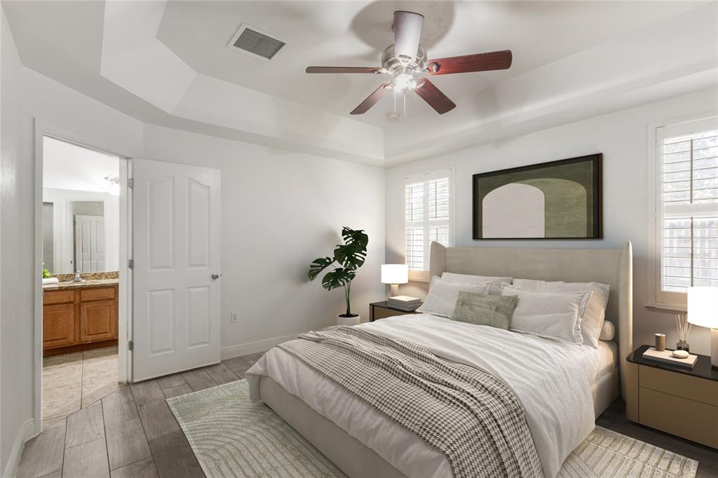 7909 Southwest 87th Terrace Gainesville, FL 32608 - Photo 12 of 17 a bedroom with a large bed and a chandelier