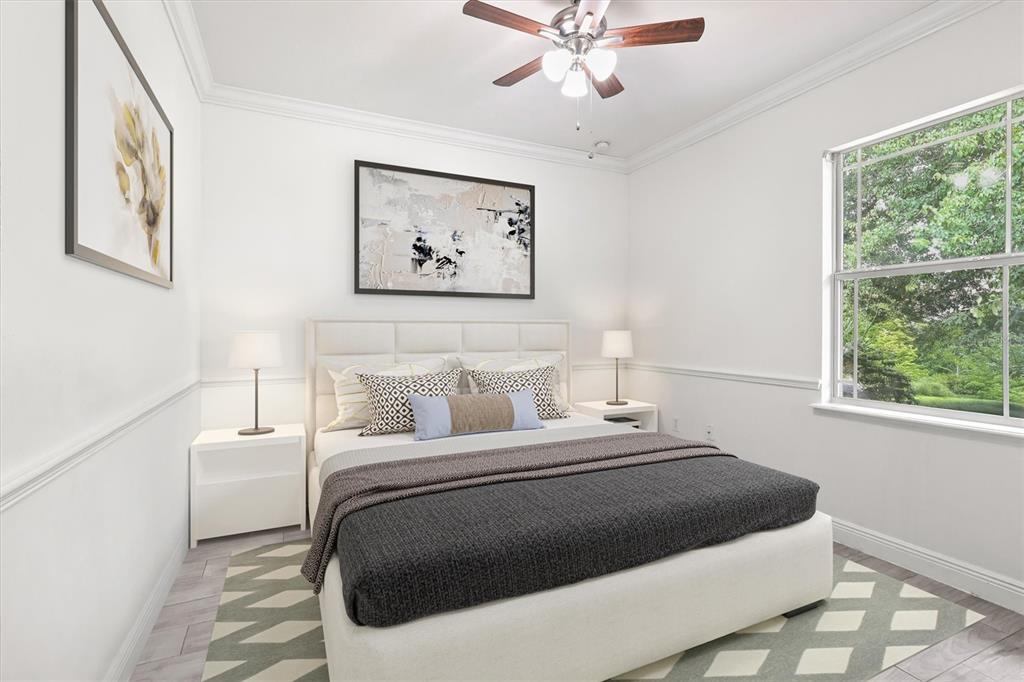 7909 Southwest 87th Terrace Gainesville, FL 32608 - Photo 13 of 17 a bedroom with a large bed and a chandelier