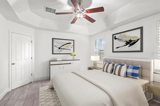 a bedroom with a large bed and a chandelier