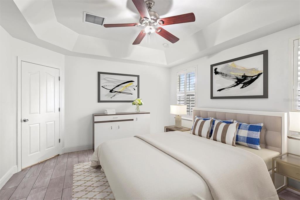 7909 Southwest 87th Terrace Gainesville, FL 32608 - Photo 5 of 17 a bedroom with a large bed and a chandelier