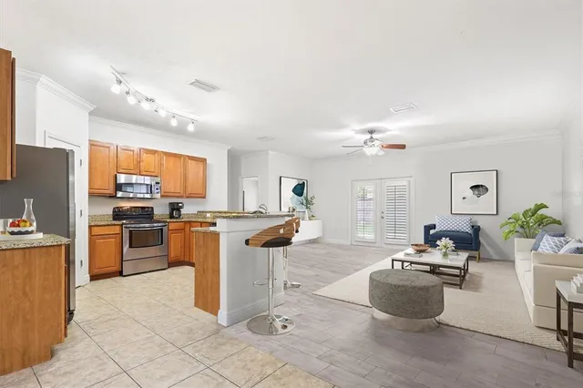 a living room with furniture flowerpot and a window