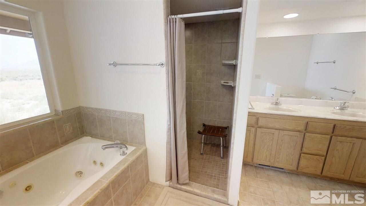 6080 Range Reno, NV 89510 - Photo 13 of 33 a bathroom with a tub sink and mirror