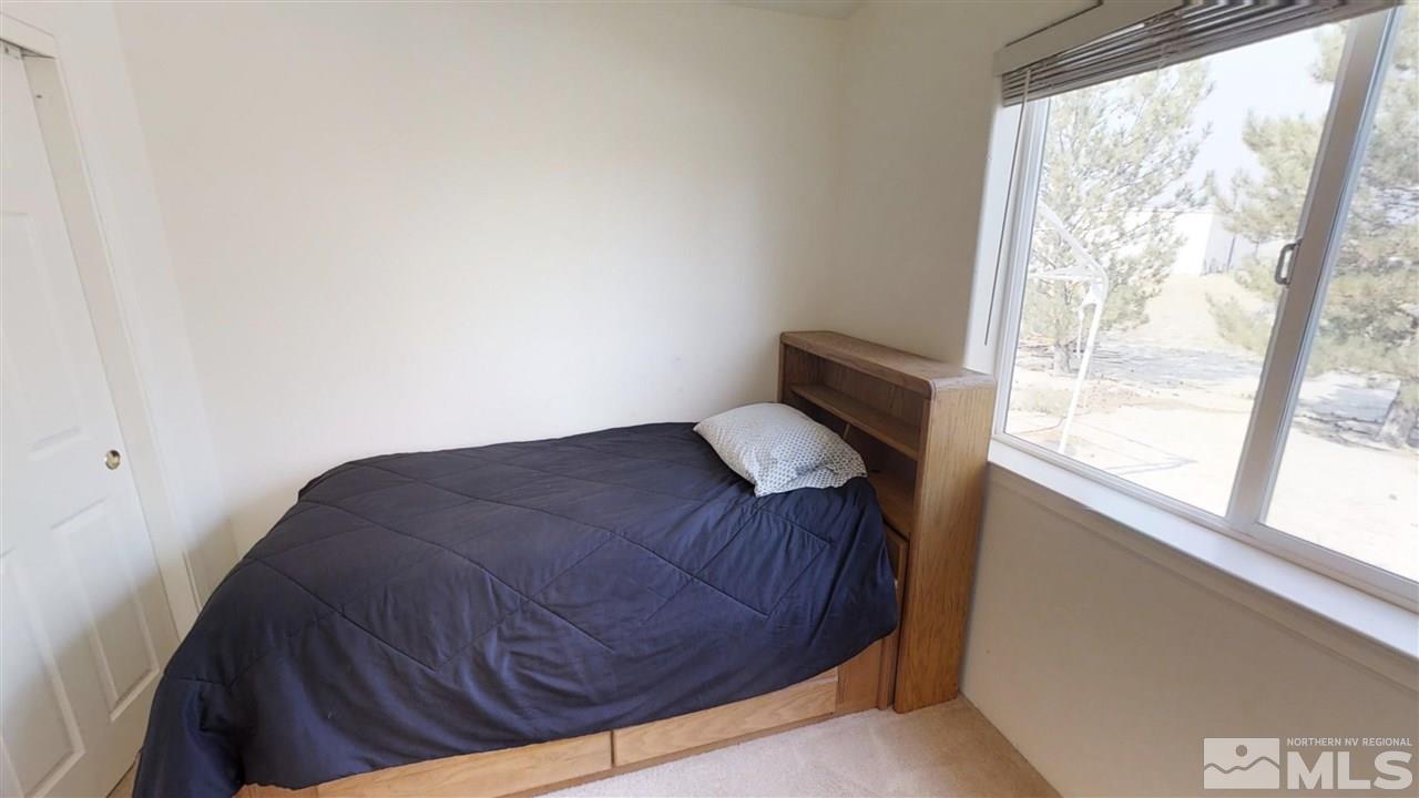 6080 Range Reno, NV 89510 - Photo 16 of 33 a bedroom with a bed and a window