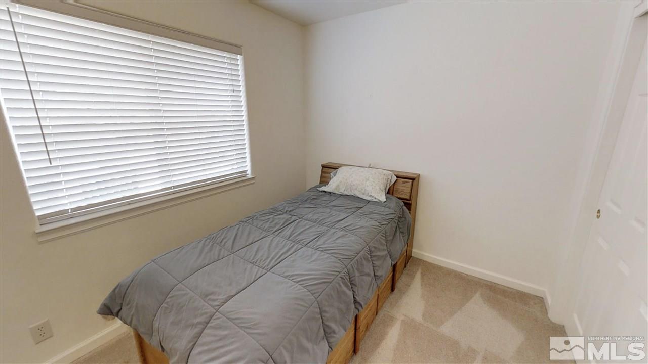 6080 Range Reno, NV 89510 - Photo 17 of 33 a bed sitting in a bedroom next to a window