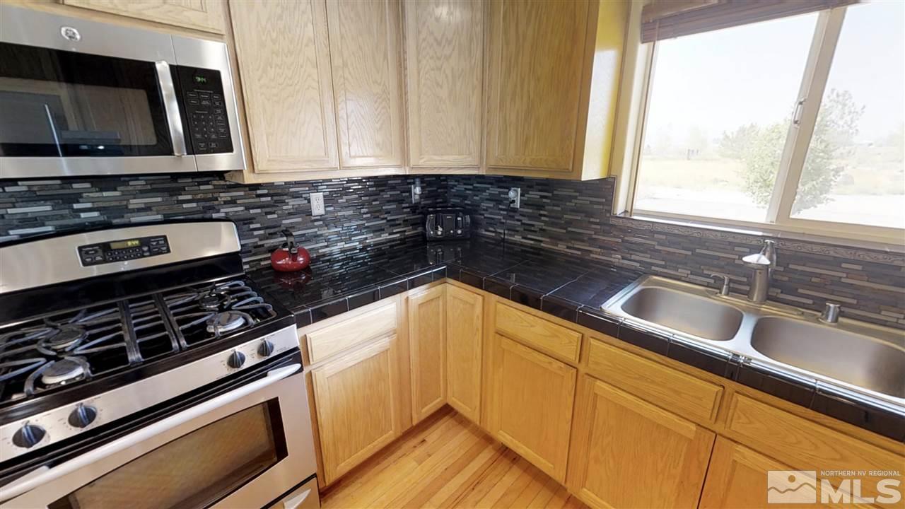 6080 Range Reno, NV 89510 - Photo 3 of 33 a kitchen with a sink a stove and cabinets