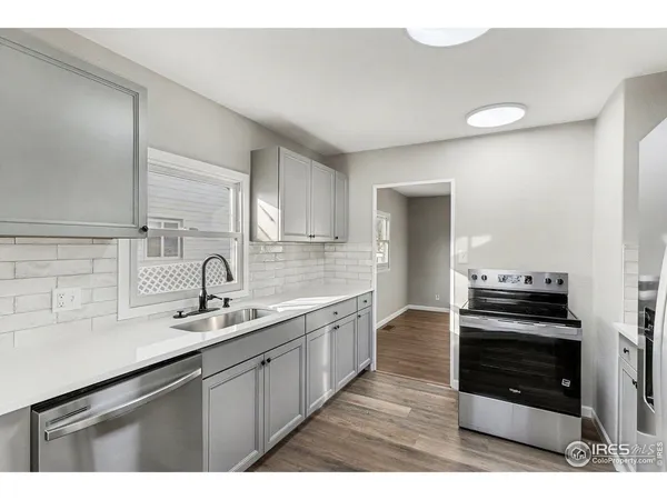 a kitchen with a sink stove and cabinets