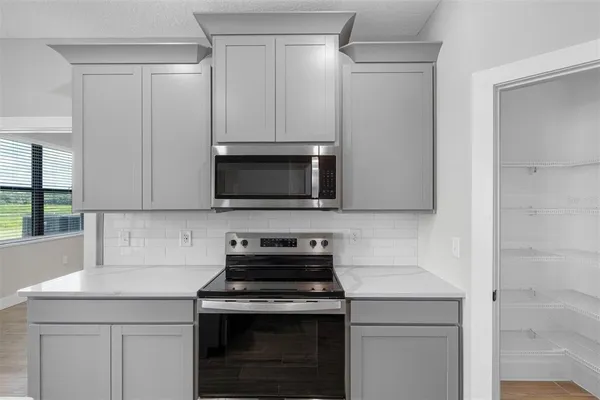 a kitchen with a stove and a microwave