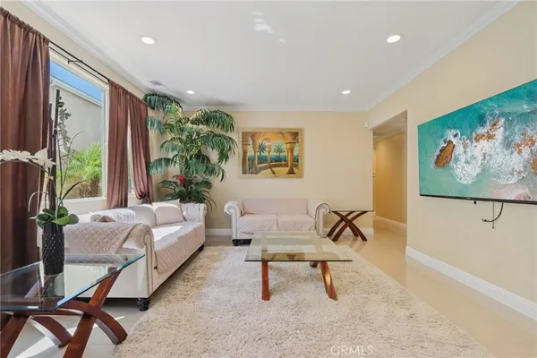 a living room with furniture and a painting on the wall